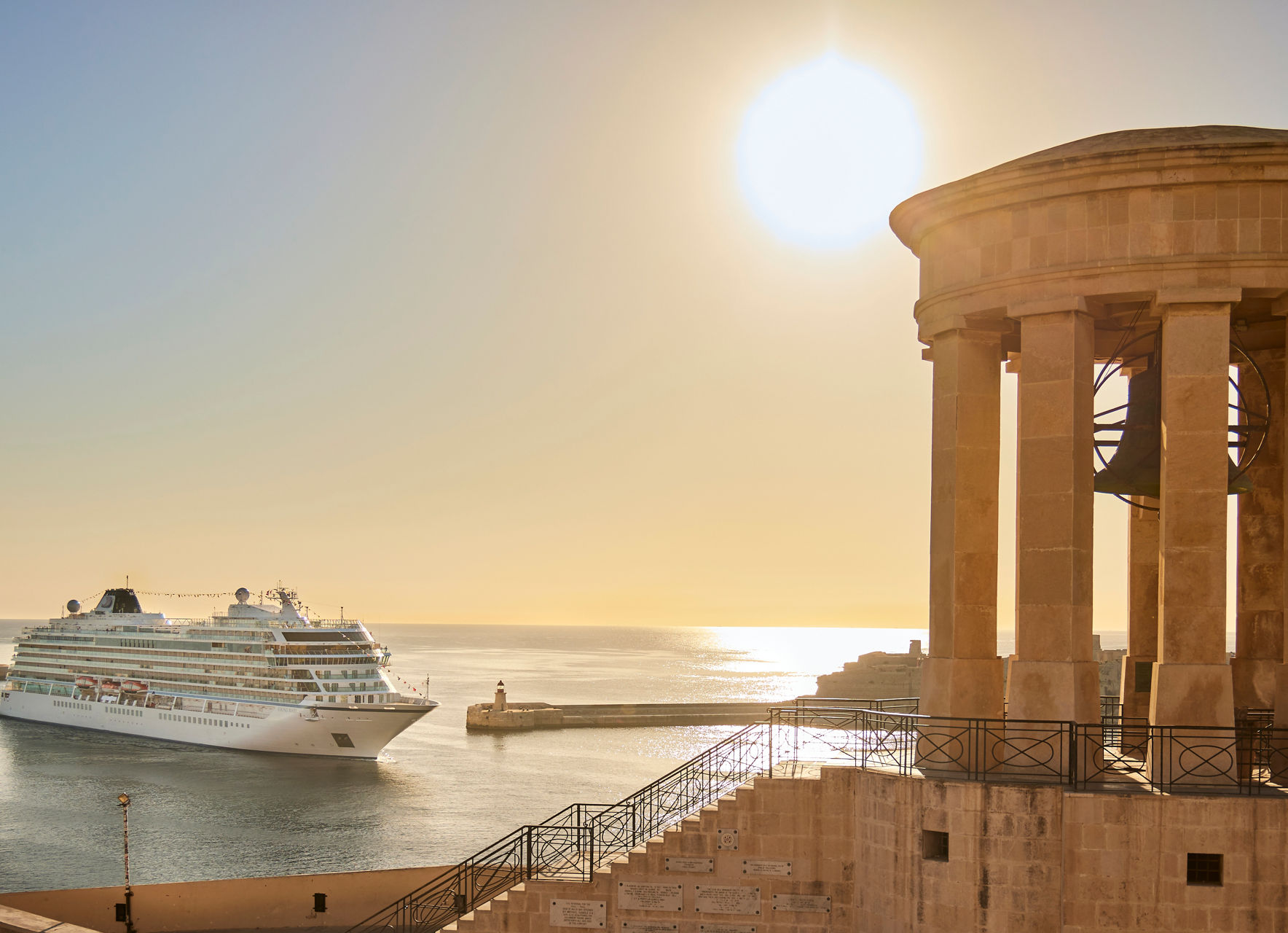 Cruise ship near historic waterfront at sunset