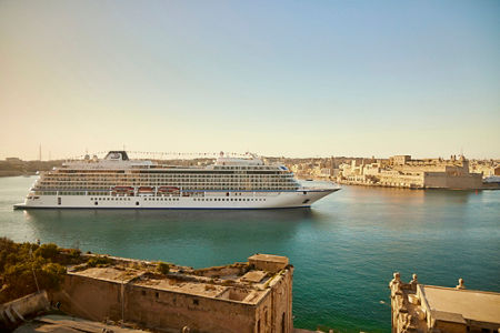 Luxury cruise ship docked in scenic harbor