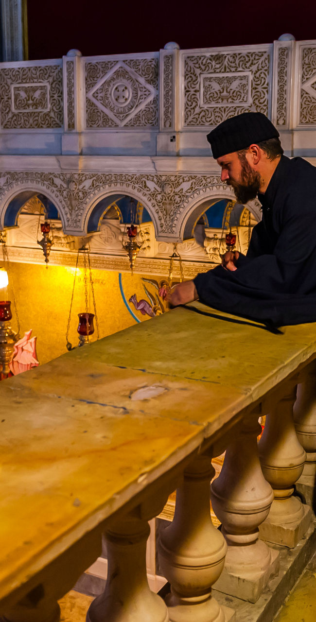 Orthodox priest in ornate church interior