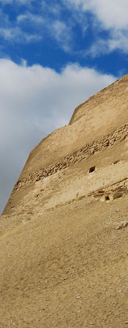 Ancient desert pyramid under dramatic sky
