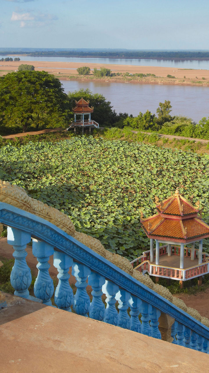 Scenic view of riverside garden with gazebos