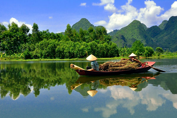 Traditional boat on serene mountain river