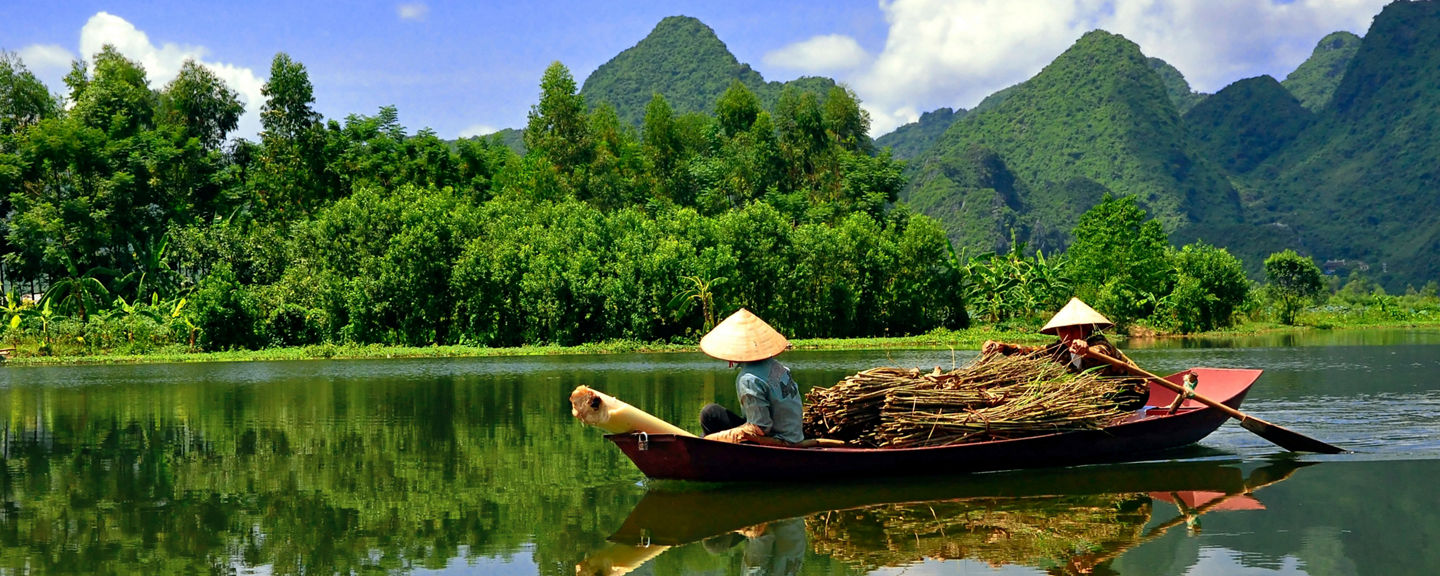 Traditional boat on serene mountain river