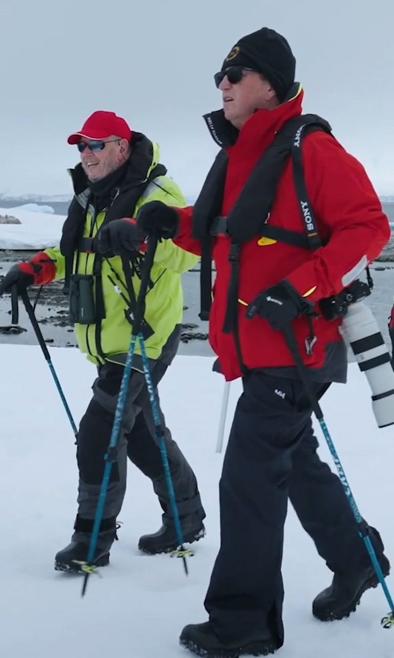 Group Trekking Across Snowy Arctic Landscape