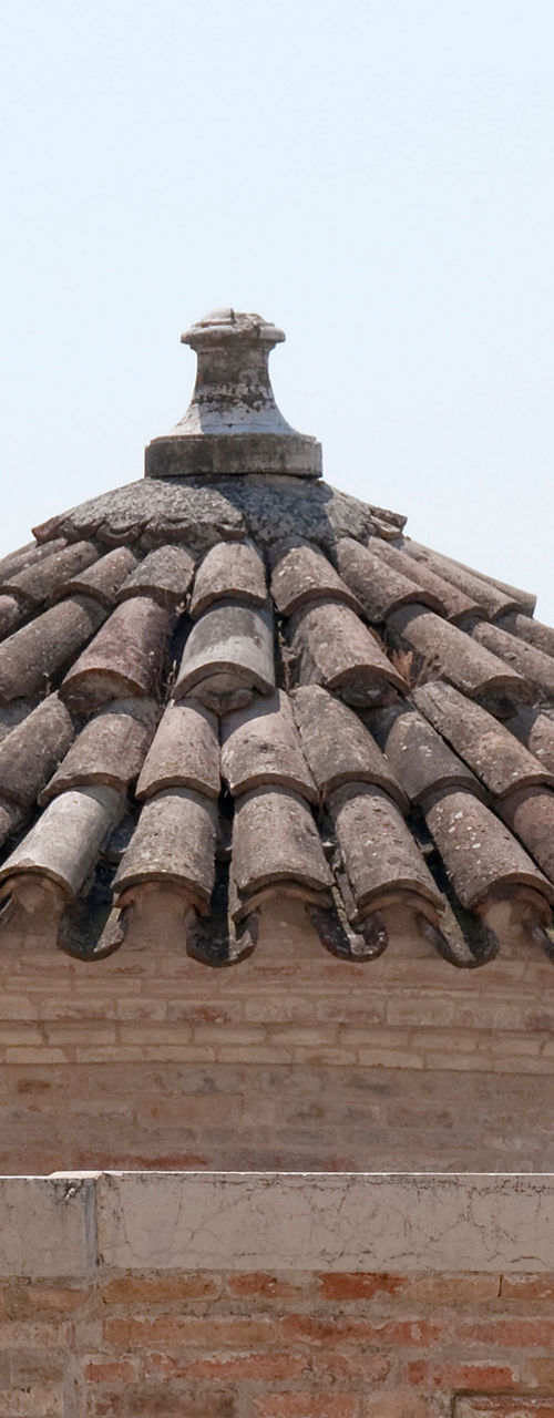 Historic statue with terracotta rooftops