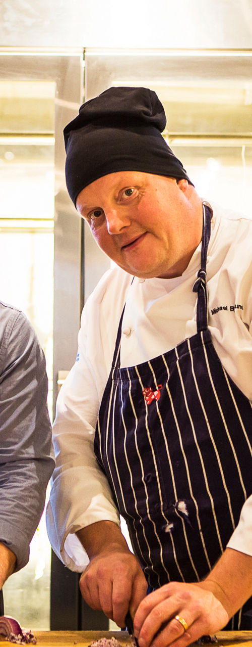 Chefs preparing food in modern kitchen