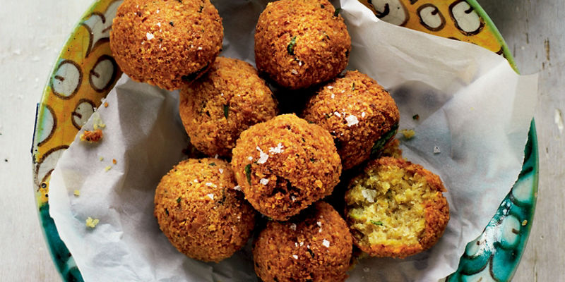 Crispy falafel with hummus and water glass