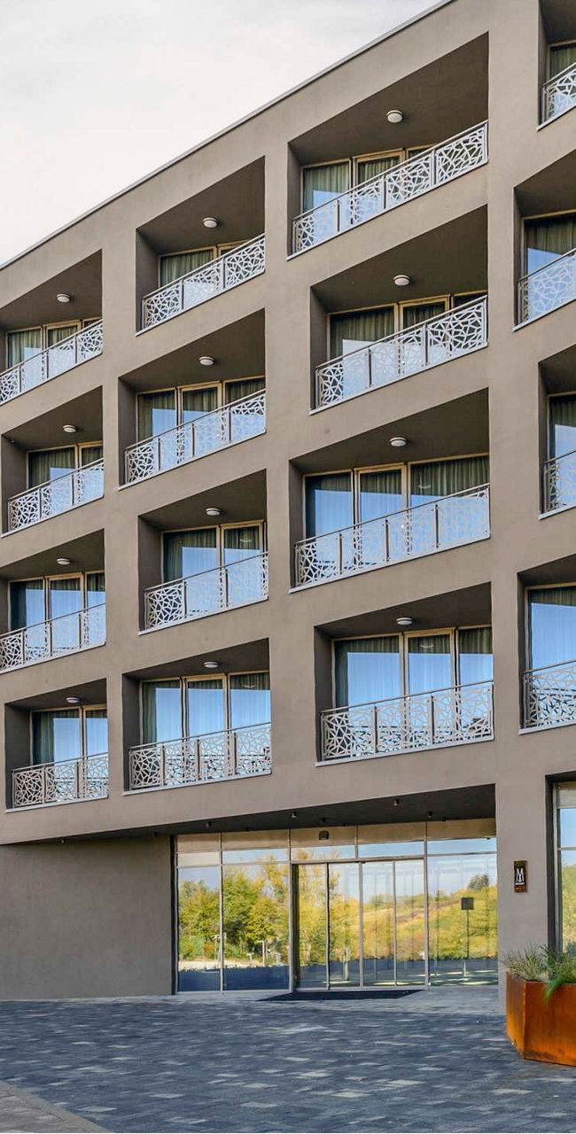 Modern hotel building with scenic backdrop