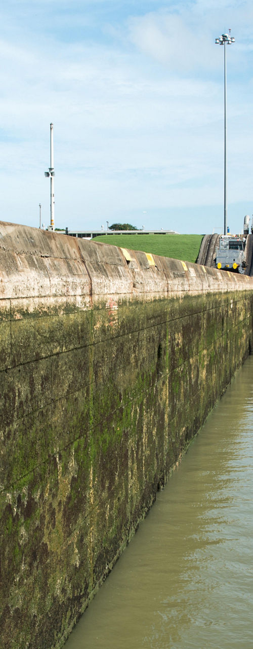 Workers oversee ship in canal lock