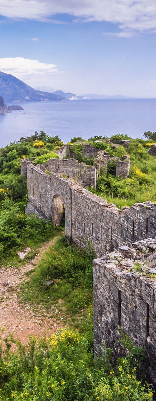 Scenic coastal ruins with lush greenery