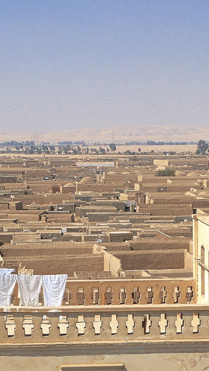 Desert town with church tower and cross