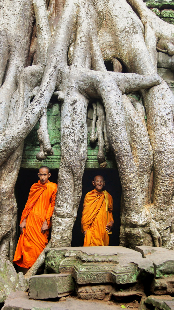 Monks in orange robes at ancient temple