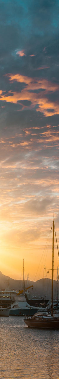 Sunset over marina with sailboats
