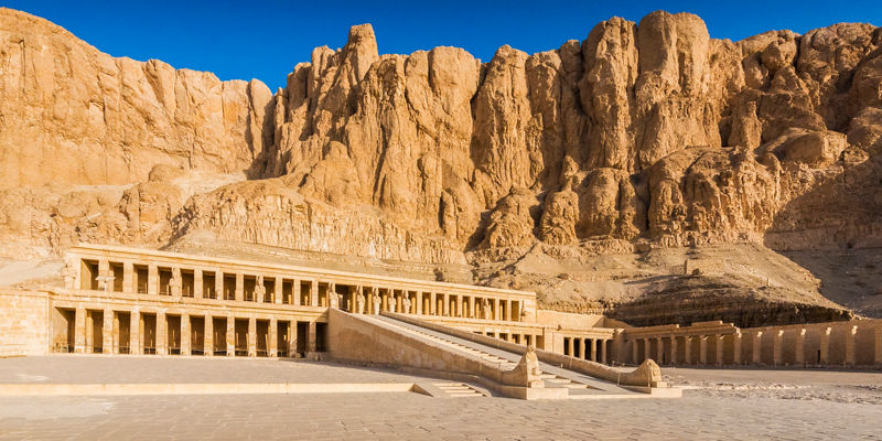 Ancient Egyptian temple against rocky cliffs