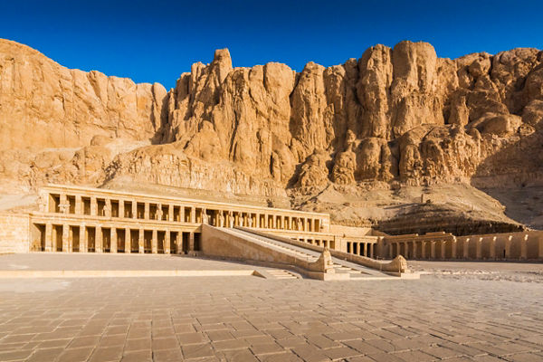 Ancient Egyptian temple against rocky cliffs