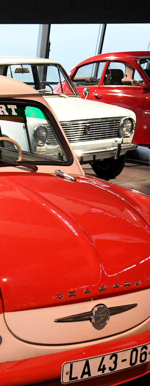 Vintage red and white car on display in museum