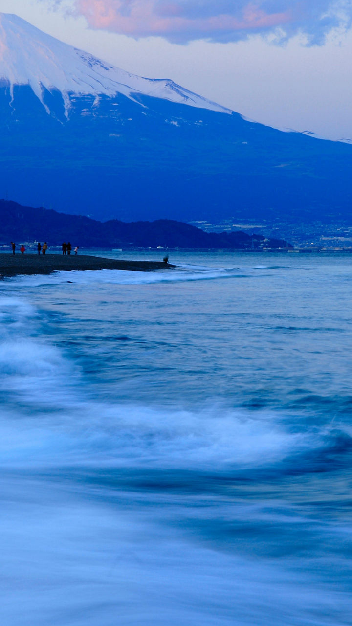 Mount Fuji at sunset with ocean waves