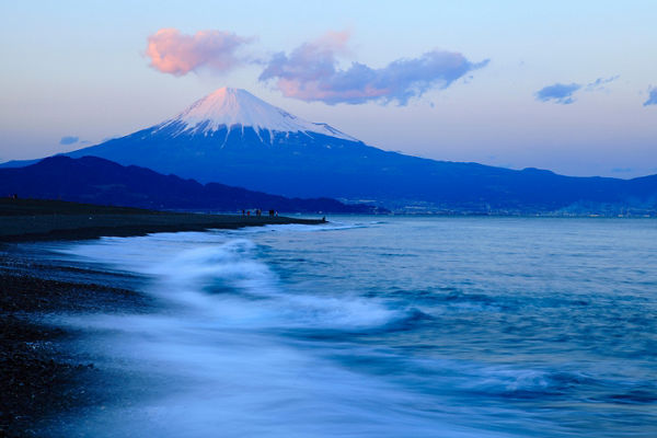 Mount Fuji at sunset with ocean waves