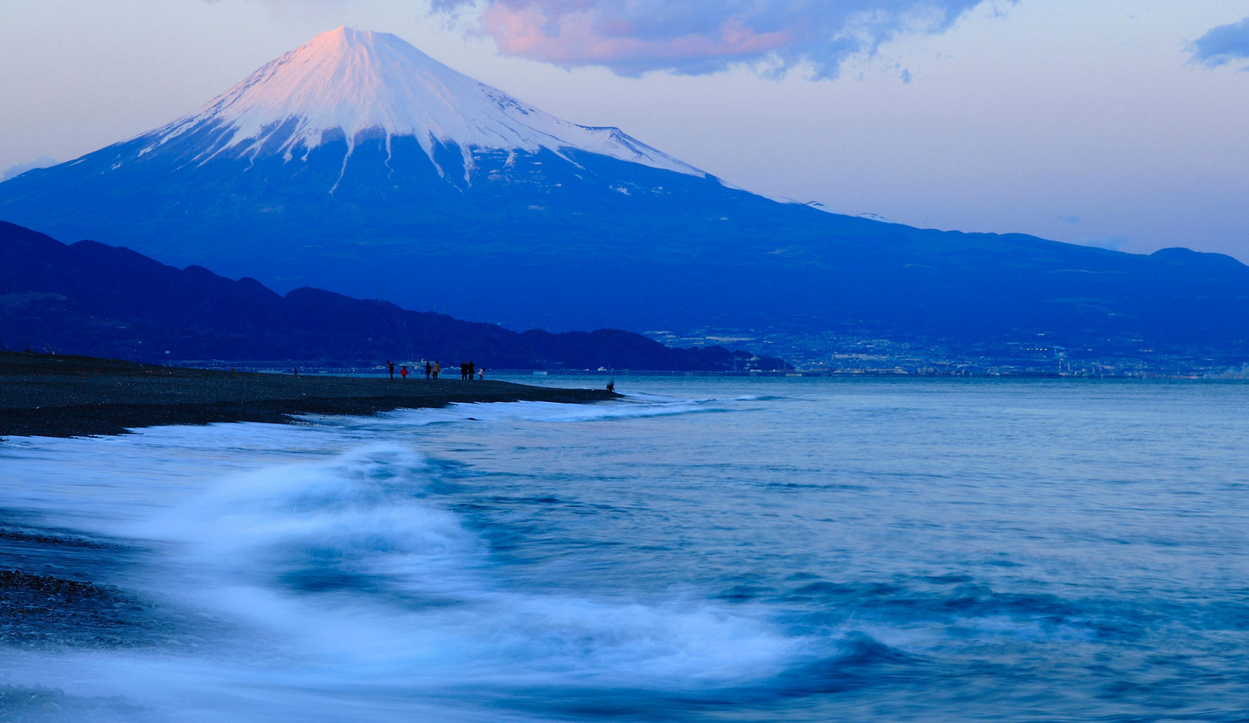Mount Fuji at sunset with ocean waves