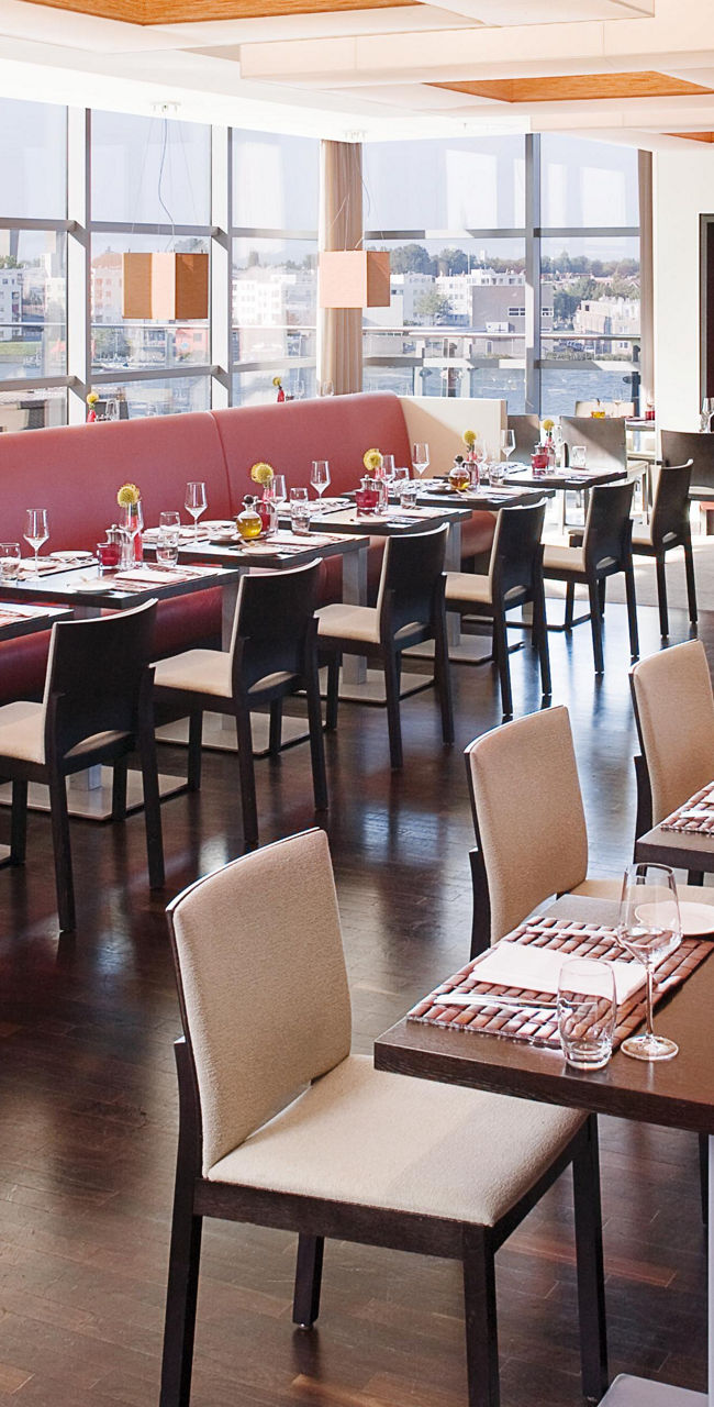 Modern restaurant with red seating and city view