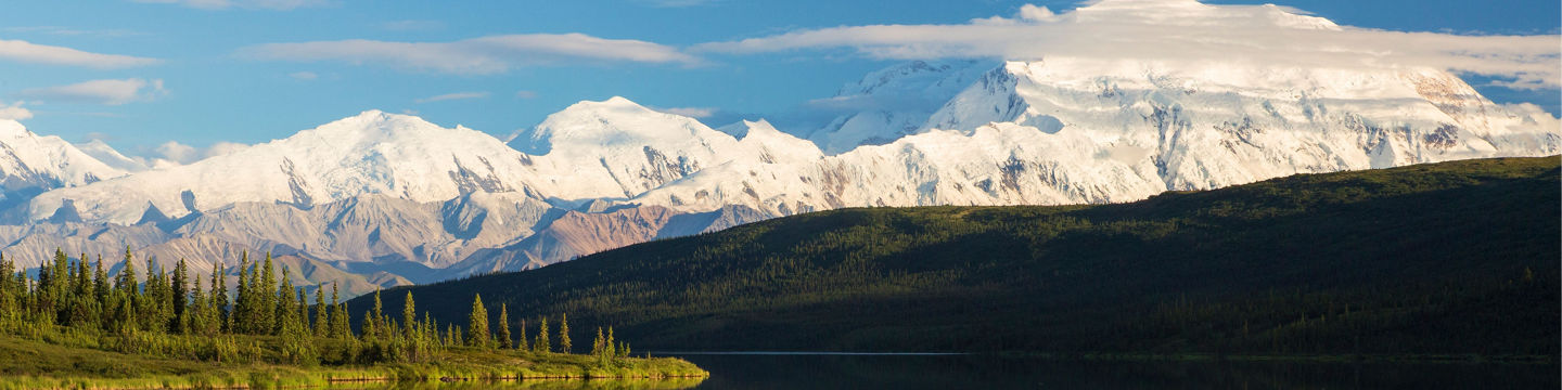 Snow-capped mountains reflected in calm lake