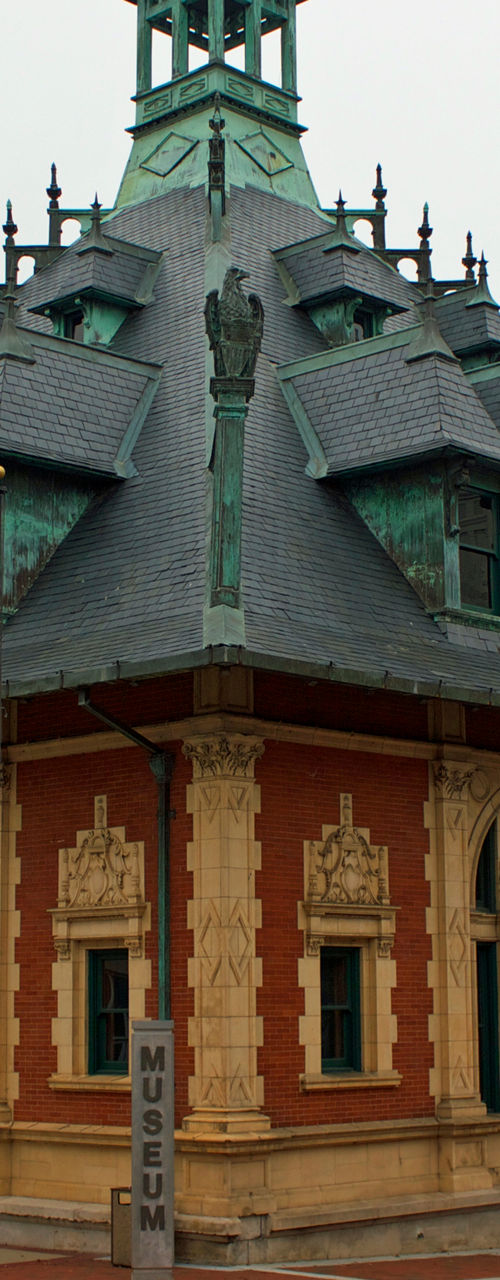 Historic red brick building with green accents