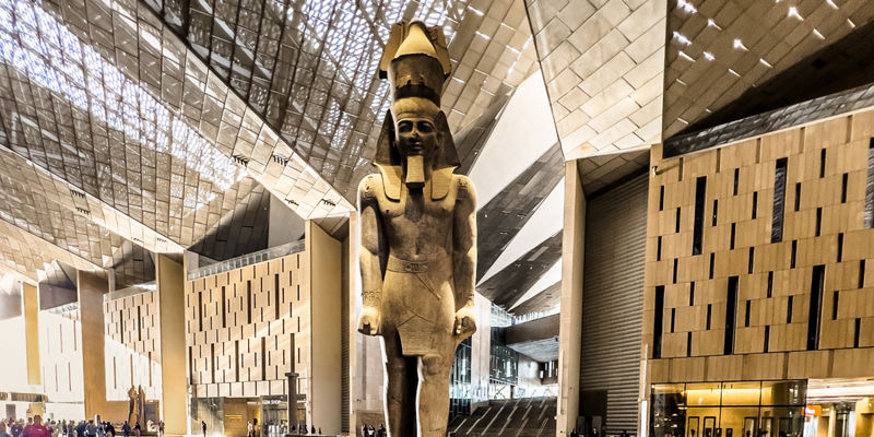 Grand Egyptian Museum statue in modern atrium