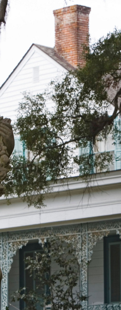 Historic statue in front of colonial house