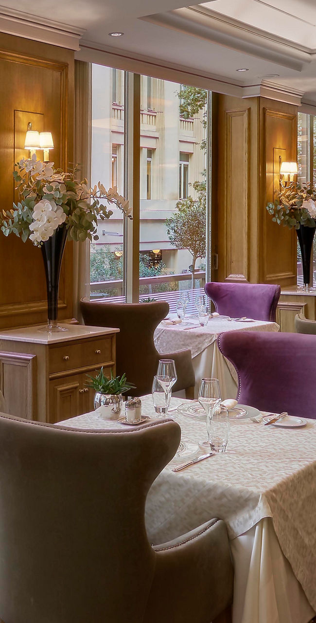Elegant restaurant with purple chairs and table settings