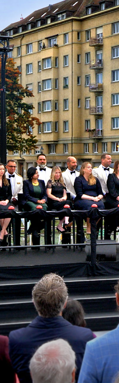 Outdoor ceremony with large audience and stage