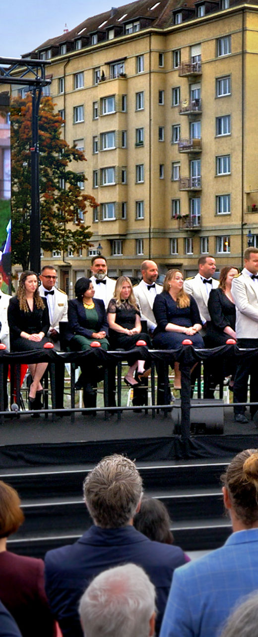 Outdoor ceremony with large audience and stage
