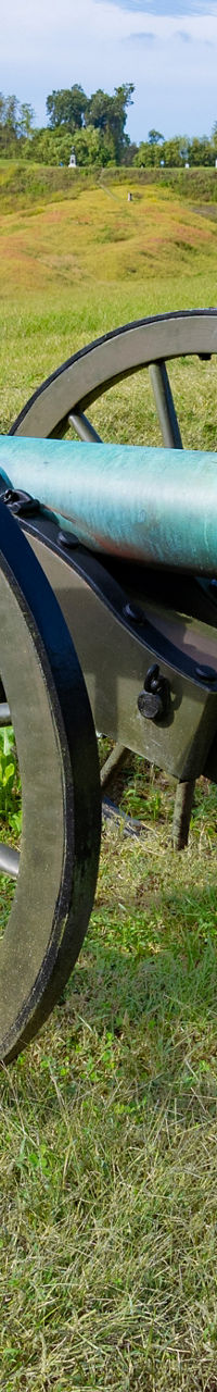Historic cannons on grassy battlefield