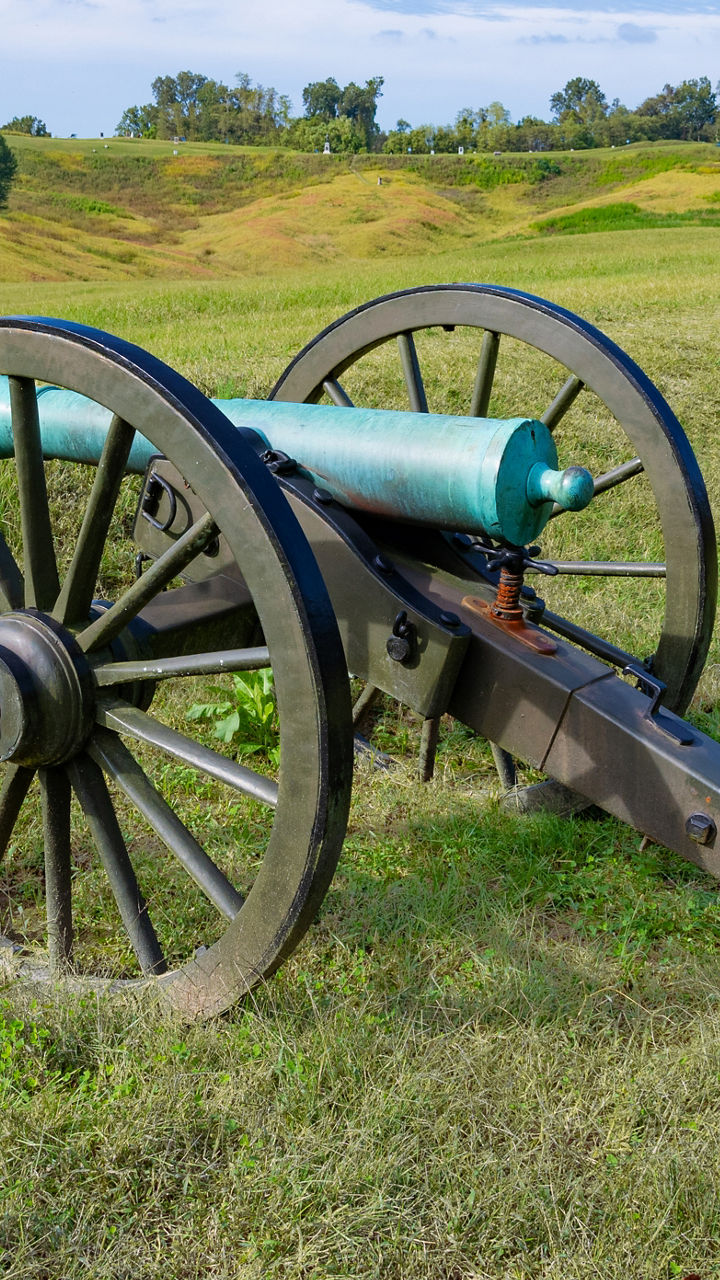 Historic cannons on grassy battlefield