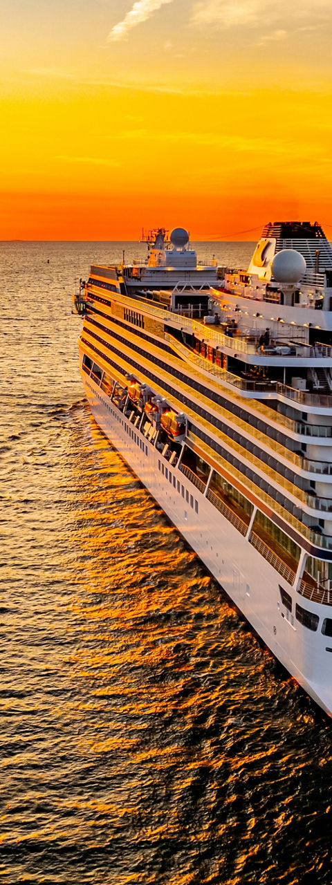 Luxury cruise ship at sunset on ocean