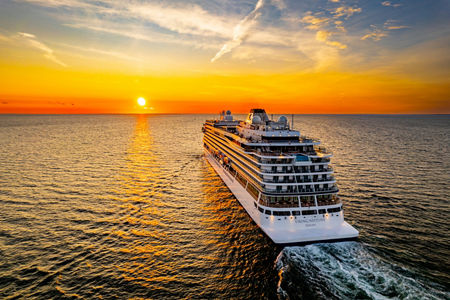 Luxury cruise ship at sunset on ocean