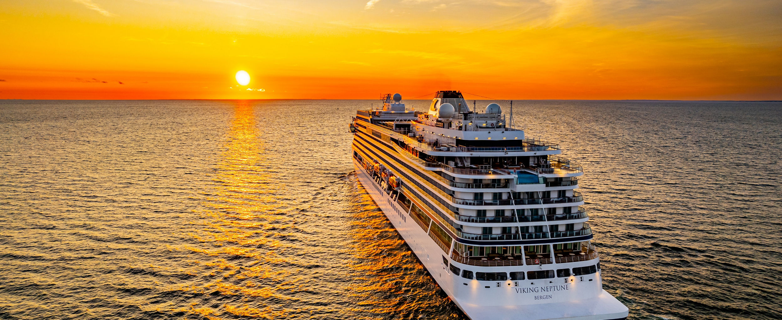 Luxury cruise ship at sunset on ocean
