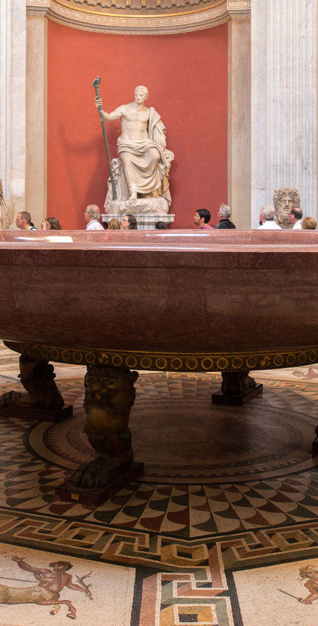 Ancient Roman statues in ornate gallery
