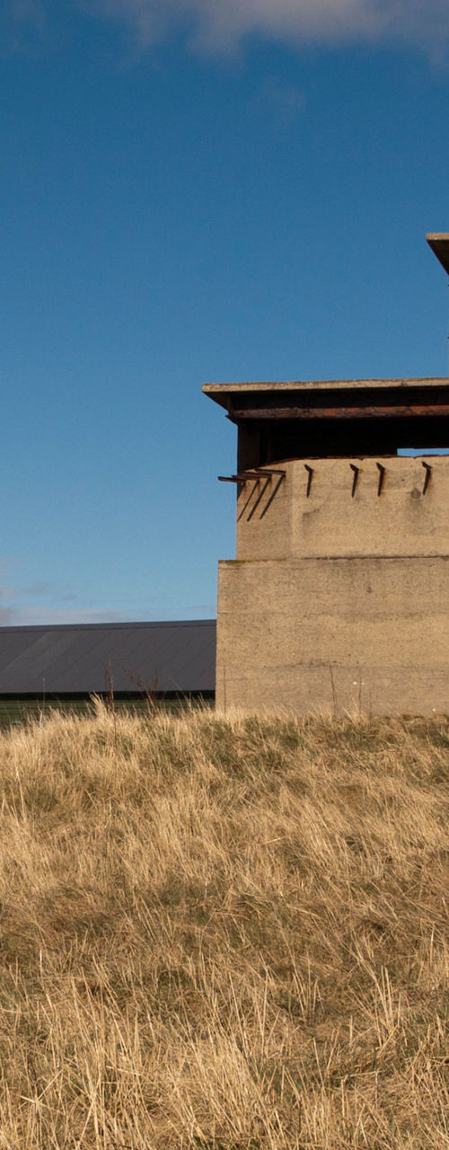 Historic concrete building in rural landscape