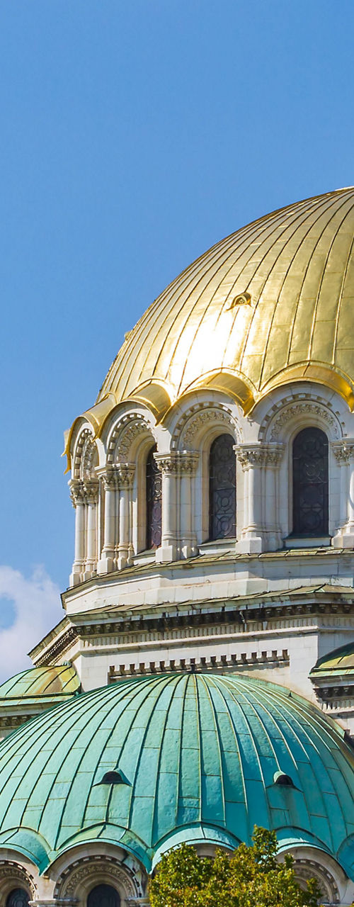 Golden-domed cathedral with lush greenery