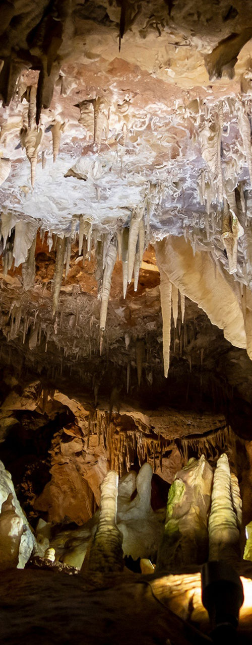 Illuminated stalactites and stalagmites in cave