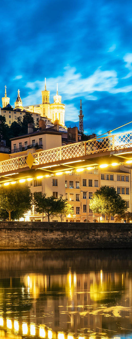 Illuminated bridge and church at dusk