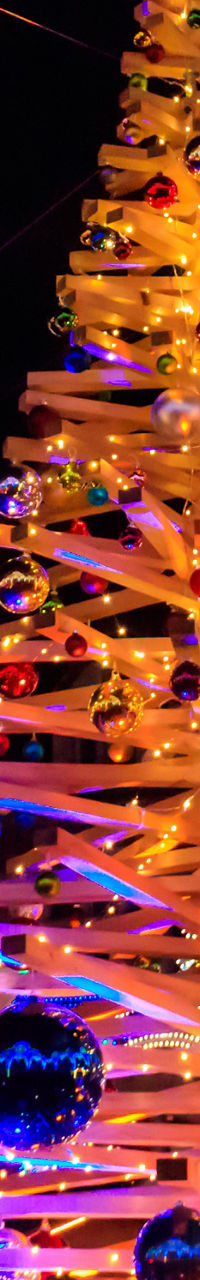 Illuminated Christmas tree in festive city square