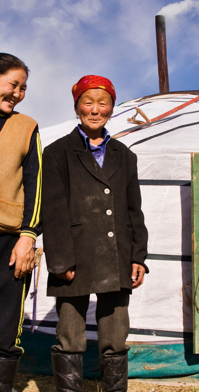 Nomadic family outside traditional yurt