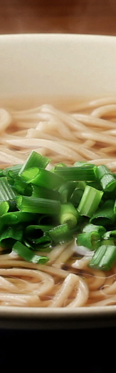 Steaming bowl of soba noodles with garnish