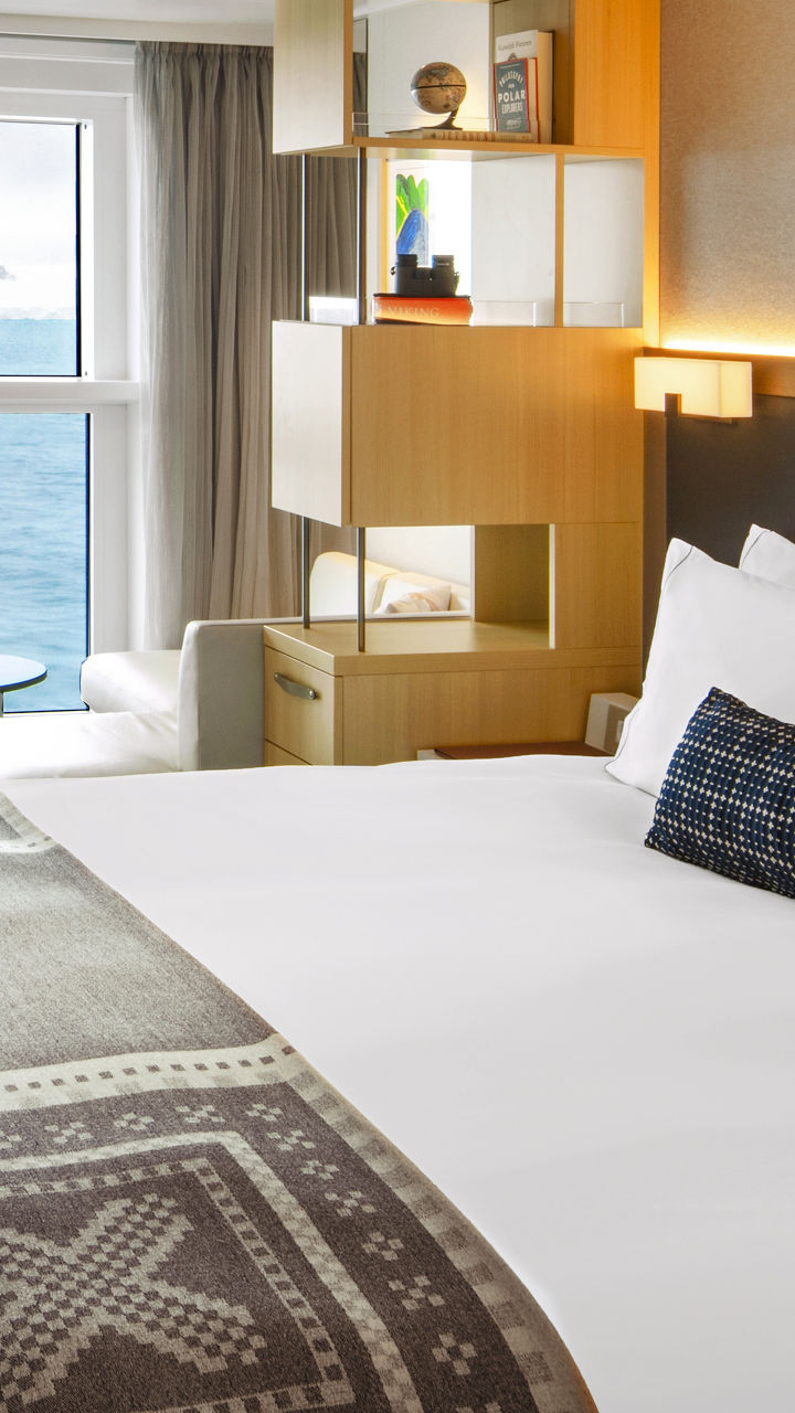 Modern ocean-view hotel room with cozy decor