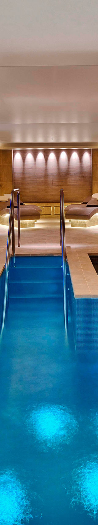 Luxury indoor spa pool with lounge seating