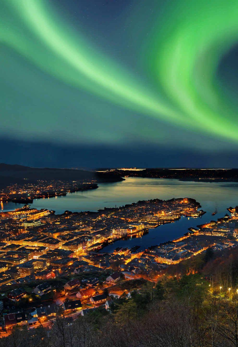 Northern Lights Over Cityscape at Night
