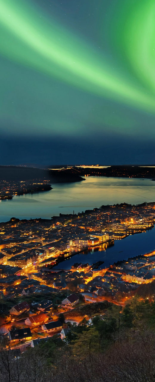 Northern Lights Over Cityscape at Night
