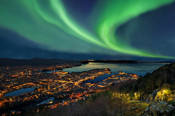 Northern Lights Over Cityscape at Night