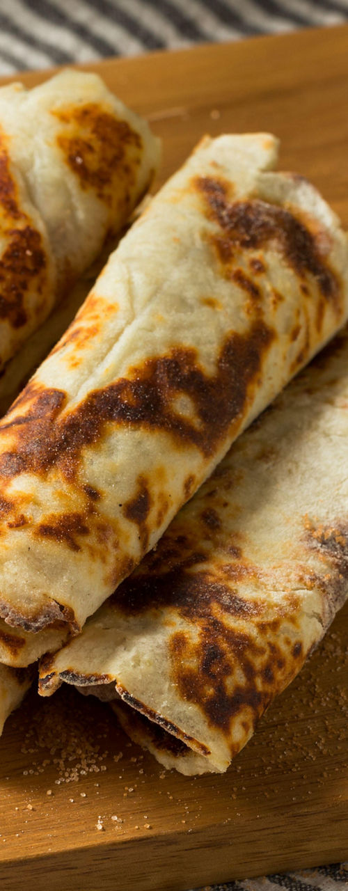 Homemade Rolled Crepes on Wooden Board